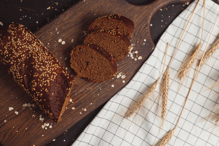 Sliced rye bread on cutting board. Whole grain rye bread with seeds.