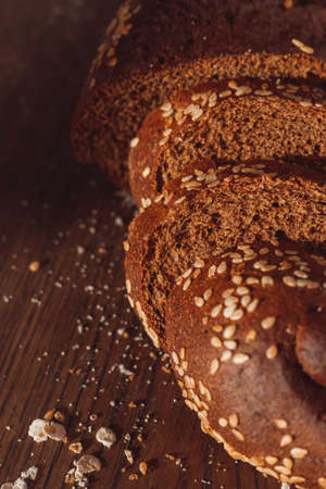 Sliced rye bread on cutting board. Whole grain rye bread with seeds.の写真素材