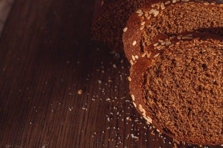 Sliced rye bread on cutting board. Whole grain rye bread with seeds.