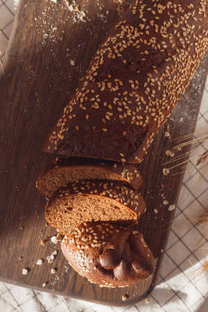 Sliced rye bread on cutting board. Whole grain rye bread with seeds.の写真素材