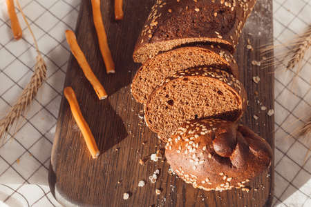 Sliced rye bread on cutting board. Whole grain rye bread with seeds.の写真素材