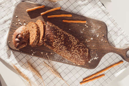 Sliced rye bread on cutting board. Whole grain rye bread with seeds.の写真素材