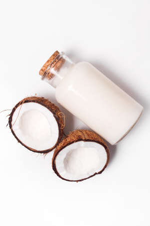 Top view organic coconut butter with fresh coconut pieces over white background.の写真素材