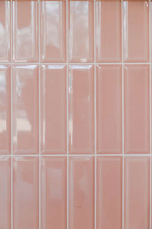 Pink glossy upright rectangular ceramic tile, background, texture.の写真素材