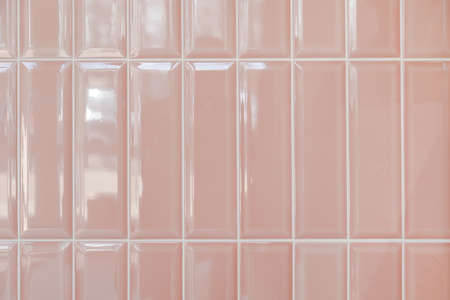 Pink glossy upright rectangular ceramic tile, background, texture.の写真素材