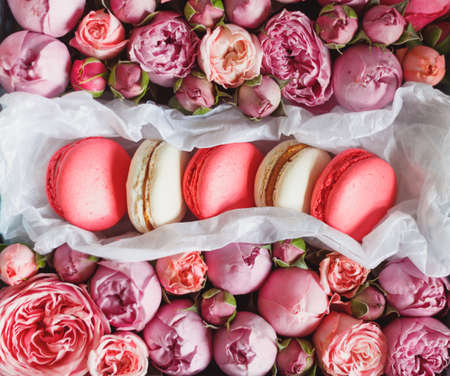 French macaron cake. Macaroons in box with fresh flowers. Top view.の写真素材