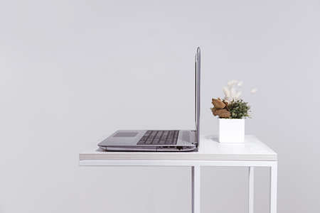 minimalist lifestyle. laptop on coffee table side view with copy space in backgroundの写真素材