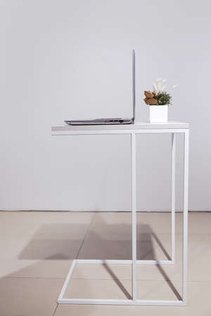 Minimalist lifestyle. laptop on coffee table side view with copy space in backgroundの写真素材
