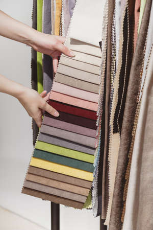 Hand pick the colorful upholstery samples in the shopの写真素材