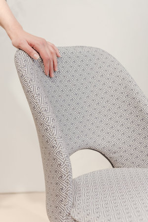 Gray chair in white concrete room for copy space. Concept of minimalism.