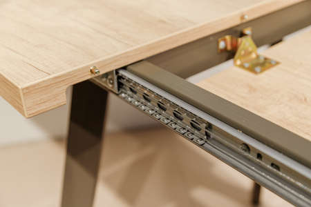 Extendable dinning table. Slide gear close up viewの写真素材