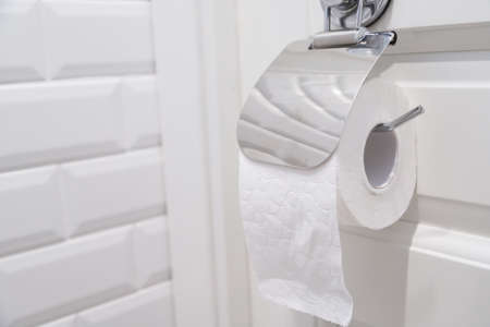 toilet paper roll hanging in bathroom close upの写真素材