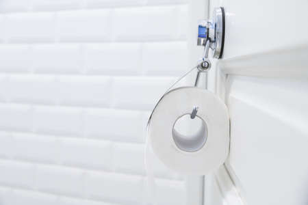toilet paper roll hanging in bathroom close upの写真素材