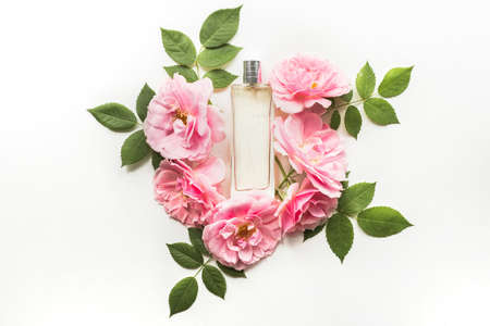 Perfume bottle with flowers isolated on white background. Flat lay, top viewの写真素材