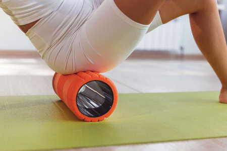 Woman doing exercises Foam Rollerの写真素材