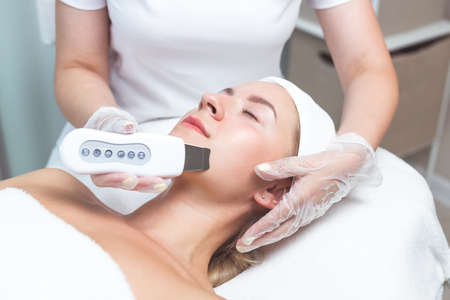 A holistic skin care treatment with an ultrasonic cleaner. professional cosmetology. skin beauty and healthの写真素材