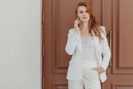 Portrait of luxury woman having mobile phone conversationの写真素材
