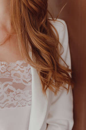 Healthy hair. Curly long hairstyle. Cropped view of brown hairs. hair styling.の写真素材
