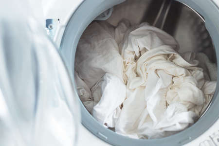 White clothes in washing machine. Open door.の写真素材