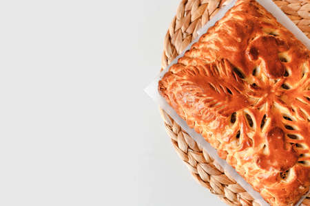 Homemade baked pie with mushrooms cooling on cloth with copy space. Flat lay, top viewの写真素材