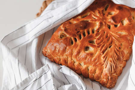 Homemade baked pie with mushrooms cooling on cloth with copy space. Flat lay, top viewの写真素材
