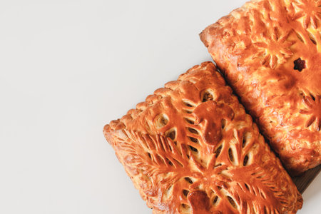 Homemade baked pies with mushrooms and berry cake cooling on cloth with copy space. Flat lay, top...