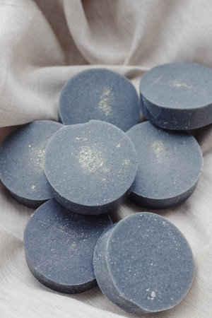 Handmade solid shampoo and conditioner bars on paper background. Copy space for text.