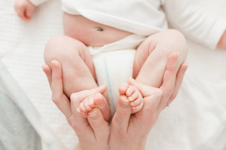 Mother changing a diaper to little baby girl.の写真素材