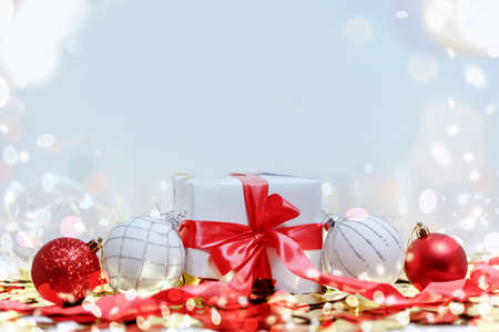 White gift box with red ribbon and christmas balls. Christmas composition card.の写真素材