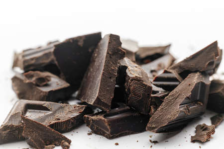 Broken to pieces dark chocolate, crushed and powder pieces. close up view, macro photoの写真素材