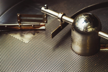 Empty industrial cooling plate with mill and holes of coffee roaster machine