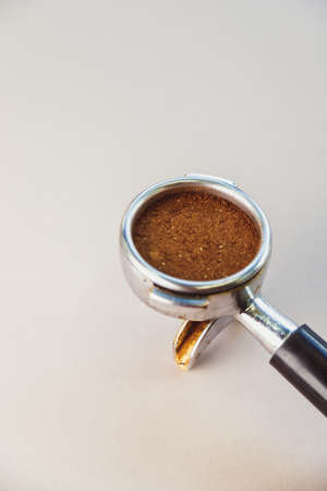 Portafilter with ground coffee on a light gray background. The view from the top.の写真素材