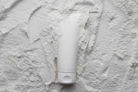 White cosmetics tube mock up on white powder background. Beauty spa medical skincare and cosmetic lotion on white decor backgroundの写真素材