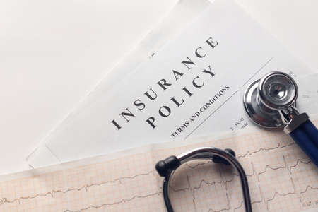 health insurance. Health insurance form, medical stethoscope, cardiogram chart. for health planning concept with copy space on whiteの写真素材
