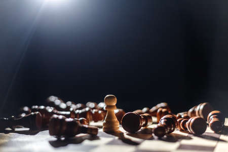 Chess. strategy ideas Planning and Decision concept business. winner white pawn surrounded by lying black chess pieces. Leadership, strength and confidence concept. good conquers evilの写真素材