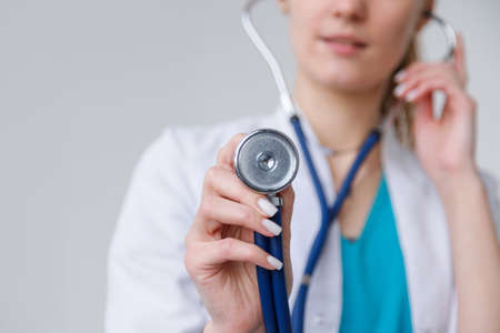 Closeup shot of stethoscope in female doctor hand ready to listen breathの写真素材