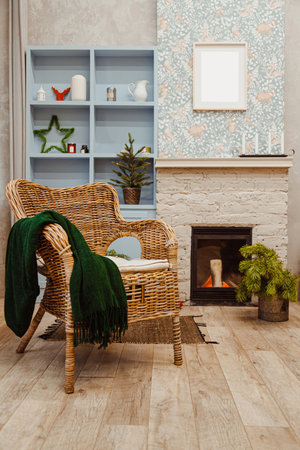 Rattan wicker chair and fireplace in the living room with Christmas decorationsの写真素材