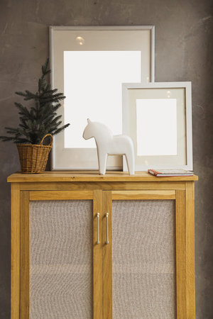 Stylish and retro space of home interior with black mock up frame, design, vintage cupboard. Cozy...