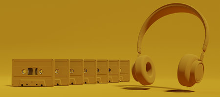 Row of Yellow Tape Audio Cassettes and headphones on yellow color background. Analog audio music concept. 3d renderingの写真素材