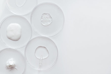 Pipette with Sample of Gels Cosmetic Product in Petri Dish on white background, top view, flat lay