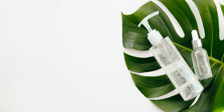 Cosmetics Oxygen Gel in bottle with green tropical leaf on white background. Natural beauty spa product concept.の写真素材