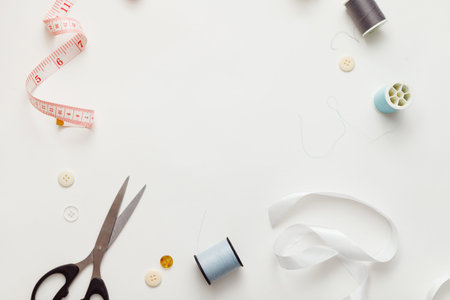 Sewing accessories for repairing clothes, layout on a white background, top view.