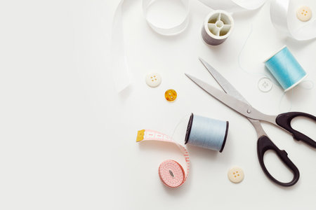 Sewing accessories for repairing clothes, layout on a white background, top view.の写真素材