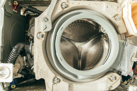 Gasket mount of a front loading washing machine being serviced without front cover, disassembled