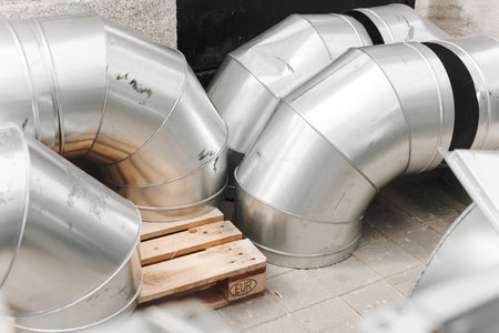 Stainless steel pipes for heating and ventilation in the kitchen.の写真素材