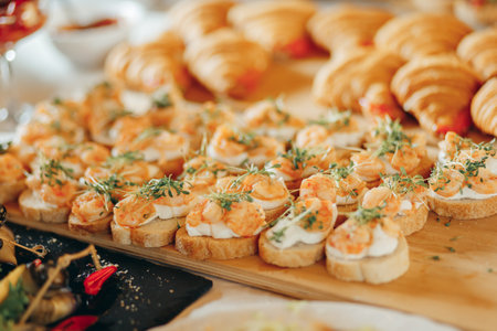 Appetizer toasted bruschetta with shrimps on wooden boardの写真素材