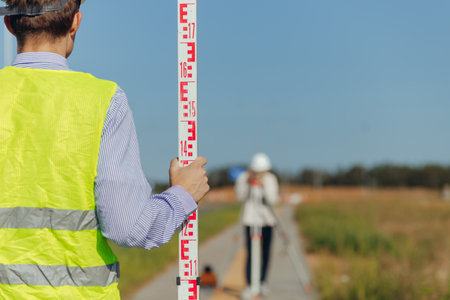 Team survey construction engineer use level survey camera.の写真素材