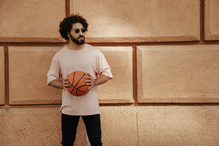 Young Arabian with a beard and afro hairstyle with basketball ballの写真素材