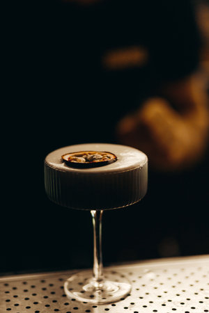 sweet and sour refreshing cocktail decorated with passion fruit on the bar counterの写真素材