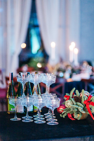 A pyramid of wide champagne glasses on deep blue tablecloth at eventの写真素材